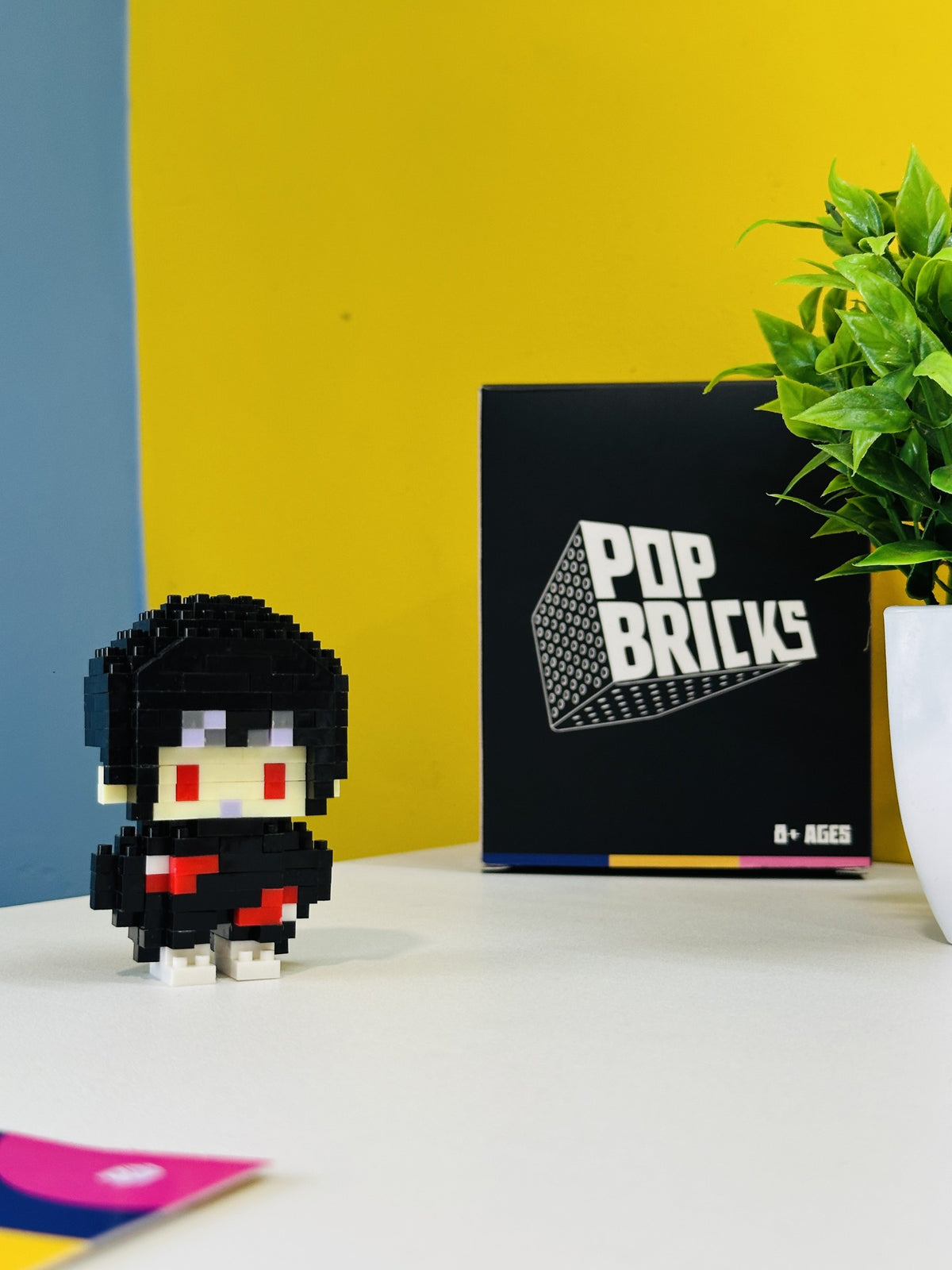 Itachi Pop Bricks mini figure with branded packaging